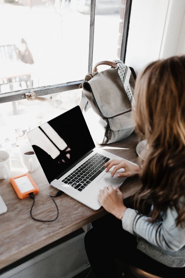 close-up-photography-of-woman-sitting-beside-table-while-3178818